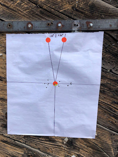 Target with 10 degree lines and plumb bob with bullet holes