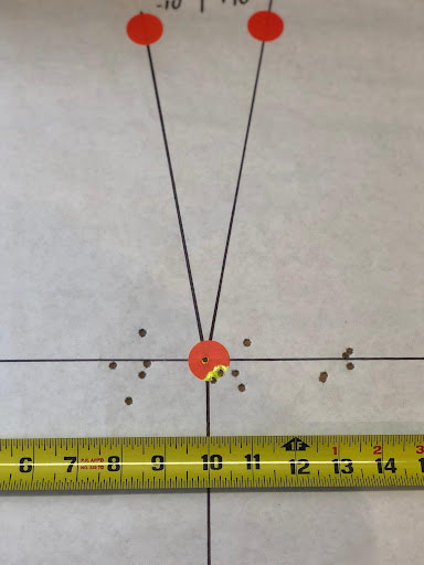 Bullet holes showing offset of 2.5" in either direction