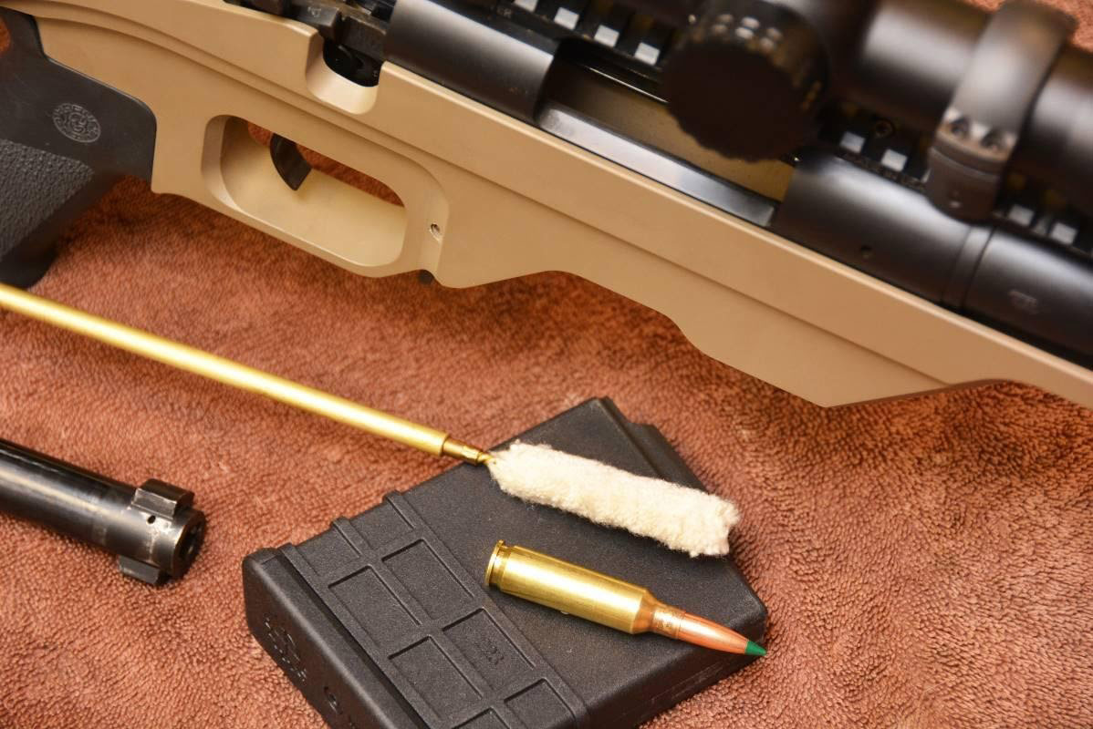 Rifle cleaning kit with cartridge for scale